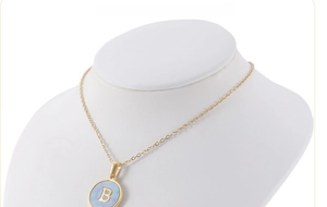 Detailed view of 18K gold stainless steel necklace with blue shell pendant and letter B