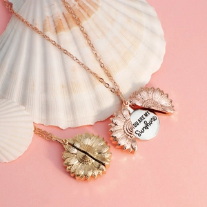 Close-up of sunflower pendant revealing the engraved You Are My Sunshine message