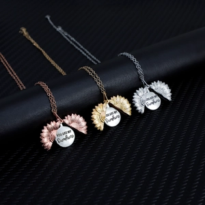 Three-color sunflower locket necklaces with You Are My Sunshine engraving on dark carbon fiber
