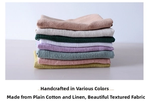 Stack of colorful linen cotton napkins with textured waffle weave for home kitchen decor