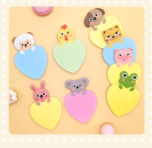 Detailed view of colorful heart-shaped sticky notes with cute cartoon animal designs