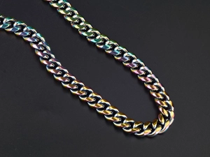 Macro shot of colorful iridescent cuban link chain with rainbow oil slick finish