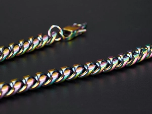 Close-up of rainbow iridescent cuban link chain with secure spring clasp detail