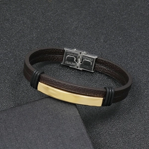 Close-up of men's brown leather bracelet with double-layer band and gold stainless steel clasp