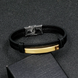 Detail of minimalist black leather men's bracelet with gold stainless steel clasp