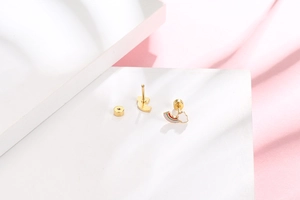Detail of gold plated rainbow and cloud earrings with colorful enamel finish and secure backs