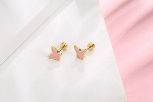 Detailed macro shot of pink butterfly screw-back earrings in polished gold titanium steel