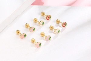 Detail of colorful strawberry stud earrings in gold-tone steel with secure screw-back design