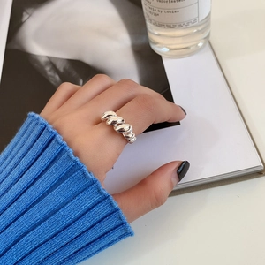 Silver twisted rope ring shown on index finger with a French minimalist retro aesthetic