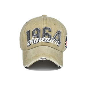 Close-up of 1964 America embroidery on khaki washed denim baseball cap with distressed edges