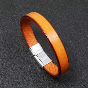Detailed view of orange leather bracelet with a polished silver magnetic clasp closure