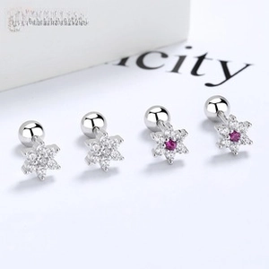 Detailed macro view of 925 silver snowflake stud earrings with zircon and screw backs