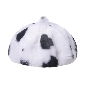 Detail of plush faux fur beret with black and white cow print texture and top accent
