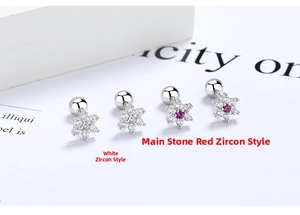 Detailed close-up of snowflake stud earrings with white and red cubic zirconia in silver