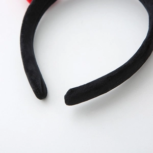 Close-up of the soft black plush texture and fine stitching on the Halloween devil horn headband