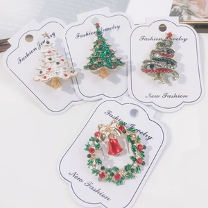 Set of four Christmas tree and wreath brooches with colorful rhinestones and enamel finish
