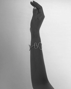 Artistic close-up of a 925 sterling silver woven knot bracelet on a model wrist