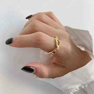 Minimalist gold chain style sterling silver open ring on model with white shirt