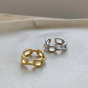 Detail of minimalist geometric chain open rings in polished gold and silver finishes