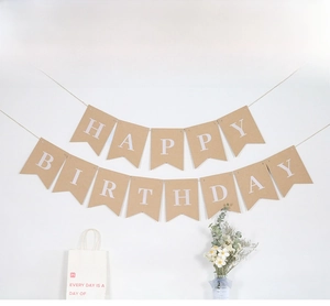 Close-up of vintage kraft paper fishtail banner with white Happy Birthday lettering