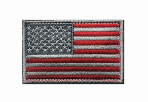 Macro detail of USA flag embroidery patch showing premium red white blue stitching