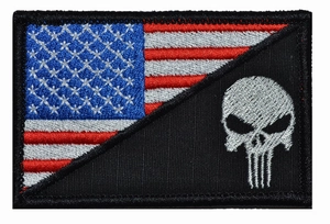Detail of USA flag embroidery patch with silver punisher skull on black background