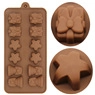 Close-up of brown silicone chocolate mold with star, gift box, and flower-shaped cavities