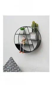 Detail of round black metal wall shelf with three tiers of geometric industrial storage
