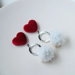 DIY jewelry set featuring red flocked hearts and white fluffy pom pom pendants