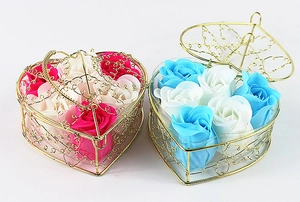 Detailed view of pink and blue soap roses in golden heart-shaped wire gift baskets