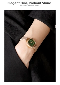 Detail of elegant rose gold mesh band watch with minimalist green square dial on wrist