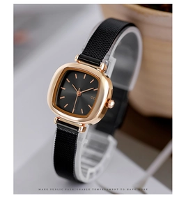 Detailed macro shot of rose gold square case with black Milanese mesh strap watch