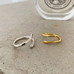 Macro detail of gold and silver S925 sterling silver minimalist wavy open rings