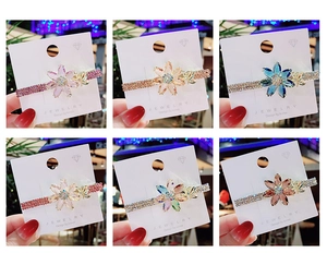 Detailed view of crystal flower hair clips in six colors with sparkling rhinestones