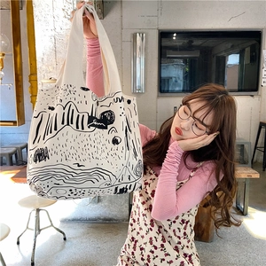 Detailed shot of large white canvas tote bag with artistic black abstract line art print