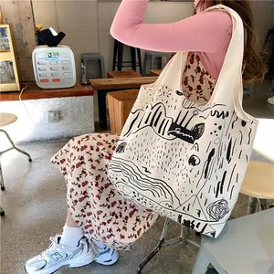 Close-up of minimalist canvas tote bag featuring black abstract nature illustration