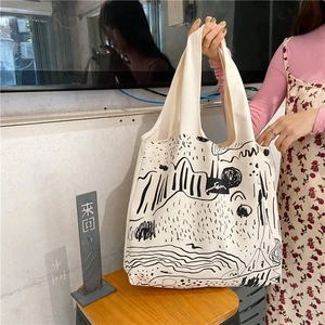 Detail of canvas tote bag featuring minimalist black abstract line art illustration