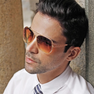 Classic gold metal aviator sunglasses with orange gradient lenses on male model
