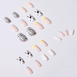 Press-on nail set with cow print, zebra patterns, and colorful French tips on white background