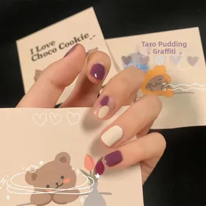 Detailed close-up of Taro Pudding Graffiti press-on nails in purple and creamy white