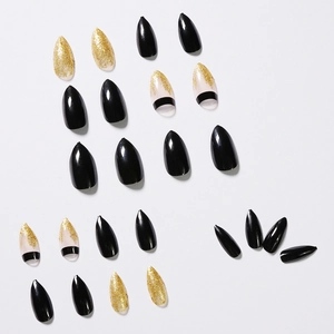 Black and gold glitter stiletto press-on nails set with glossy finish on white background