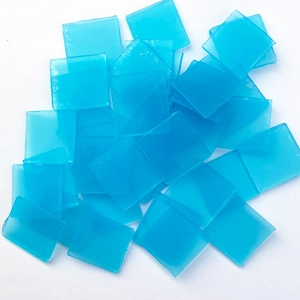 Macro shot of light blue square wax pads for diamond painting tool kits on white background