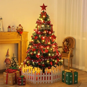 Decorated Christmas tree with lights and red bows in a cozy home setting with fireplace
