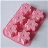 Pink silicone mold with six snowflake-shaped cavities for baking cakes and making soaps