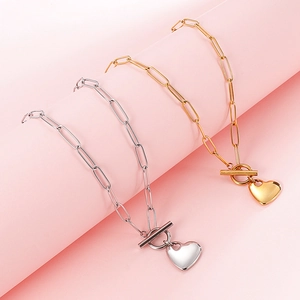 Minimalist gold and silver heart pendant necklaces with paperclip chains and T-bar toggles