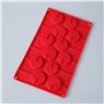 Detailed top view of red silicone mold with 15 circular cavities for DIY chocolate