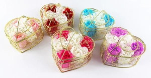 Macro shot of five heart-shaped golden wire baskets filled with colorful soap roses
