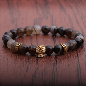 Men's retro 8mm beaded bracelet with brown agate stones and golden skull accent on wood