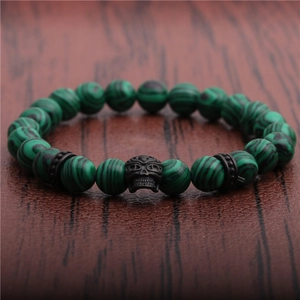 Close-up of green malachite beaded bracelet with black metal skull and spacer beads
