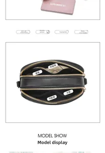 Detail of black leather crossbody bag interior showing multiple zipper compartments